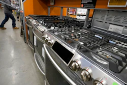 This Oct. 29, 2020 file photo, a passer-by walks past stoves on display at a Home Depot location, in Boston. Orders to U.S. factories for big-ticket goods shot up 3.4% in January 2021, pulled up by surge in orders for civilian aircraft. A category that tracks business investment posted a more modest gain, the Commerce Department reported Thursday, Feb. 24.