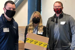 From Left: Kimball Midwest sales representative Joey Darke; director of culture, diversity and inclusion Meaghan McCurdy; and district manager Ben Darke hold a box containing donated Kimball Midwest supplies Thursday at Ford Field in Detroit. The donation supported COVID-19 mass vaccination sites at multiple NFL stadiums in partnership with the National Association of Wholesaler-Distributors.
