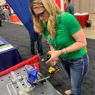 A Lawson Products associate demonstrating a product at a 2019 industrial products expo.
