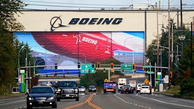 In this Oct. 1, 2020 photo, traffic passes the Boeing airplane production plant, in Everett, Wash.
