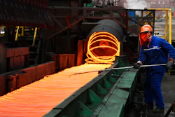 A worker manipulates coils of steel at Xiwang Special Steel, Zouping County, China, March 5, 2018.