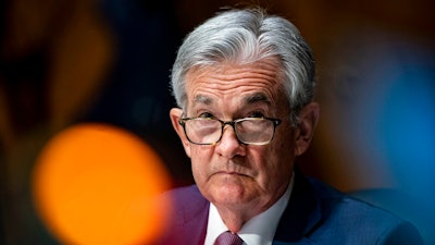 In this Dec. 1, 2020 file photo, Federal Reserve Chair Jerome Powell listens during a Senate Banking Committee hearing on Capitol Hill in Washington. Powell on Thursday, April 8, 2021 said the U.S. economy, boosted by quickening vaccinations and signs of rapid hiring, is headed toward a strong recovery, though he cautioned not all will immediately benefit.