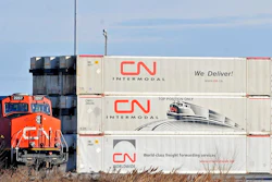 A Canadian National locomotive passes by freight containers at the Canadian National Taschereau yard in Montreal, Saturday, Nov. 28, 2009. Canadian National sweetened its offer to buy Kansas City Southern railroad Thursday, May 13, 2021, and derailed rival Canadian Pacific’s bid for the railroad that handles traffic in the United States and Mexico.
