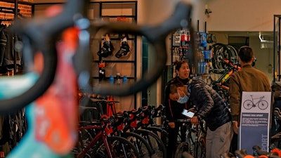 Customers wearing face masks to help curb the spread of the coronavirus look at the American bicycle brand at a retail shop in Beijing on March 2, 2021. U.S. and Chinese trade envoys talked by phone Thursday, May 27, 2021 for the first time since President Joe Biden took office, but the two sides gave no sign when negotiations on ending their tariff war might restart.