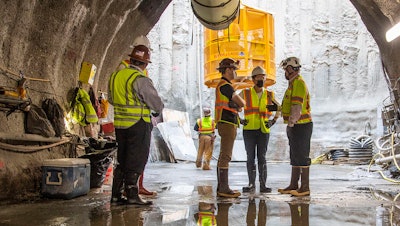 U.S. Secretary of Transportation Pete Buttigieg, center, receives a tour of an underground tunnel for the expansion of the Hartsfield–Jackson Atlanta International Airport plane train tunnel.