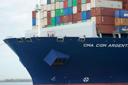 Crew members stand on the bow as the CMA CGM Argentina arrives at PortMiami, the largest container ship to call at a Florida port.