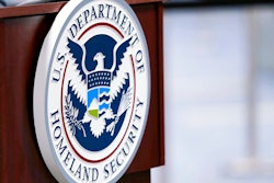 In this Nov. 20, 2020 photo, a U.S. Department of Homeland Security plaque is displayed a podium as international passengers arrive at Miami international Airport where they are screened by U.S. Customs and Border Protection in Miami.