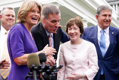 From left, Sen. Jon Tester, D-Mont., Sen. Lisa Murkowski, R-Alaska, Sen. Mark Warner, D-Va., Sen. Susan Collins, R-Maine, and Sen, Joe Manchin, D-W.Va., speak to the media after remarks by President Joe Biden on Thursday June 24, at the White House in Washington.