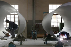 Workers perform welding on transport tanks at a factory in Nantong in eastern China's Jiangsu province Thursday, June 24, 2021.