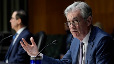 Federal Reserve Chairman Jerome Powell, right, testifies before the Senate Banking Committee on Capitol Hill in Washington, Tuesday, Dec. 1, 2020. The economy is growing at a healthy clip, and that has accelerated inflation, Federal Reserve Chair Jerome Powell says.