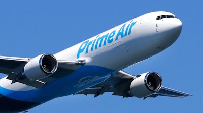 In this Friday, Aug. 5, 2016, file photo, a Boeing 767 with an Amazon.com 'Prime Air' livery flies over Lake Washington, as part of the Boeing Seafair Air Show. Amazon said Wednesday, June 30, 2021, that its carbon footprint grew 19% last year as it rushed to deliver a surge of online orders during the pandemic.