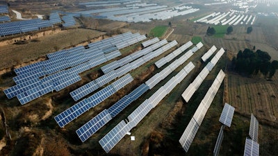 In this Nov. 28, 2019, file photo, a solar panel installation is seen in Ruicheng County in central China's Shanxi Province. China's government on Friday, June 25, 2021 criticized U.S. curbs on imports of solar panel materials that might be made with forced labor as an attack on its development and said Beijing will protect Chinese companies, but gave no details of possible retaliation.