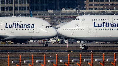 In this Feb. 14, 2019 photo, an Airbus A380, left, and a Boeing 747, both from Lufthansa airline pass each other at the airport in Frankfurt, Germany.