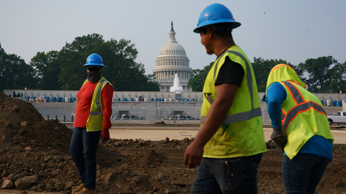 Workers repair a park near the Capitol in Washington, Wednesday, July 21, 2021. About 8 in 10 Americans favor plans to increase funding for roads, bridges and ports and for pipes that supply drinking water.