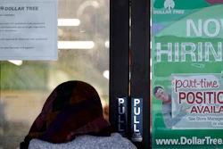 A shopper enters a retail store as a hiring sign shows in Buffalo Grove, IL on June 24.