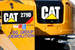 This May 8, 2019 photo shows a Caterpillar 279D Compact Track Loader, left, and 308E2 CR Mini Hydraulic Excavator, right, rear, at a demolition site in Fort Lauderdale, Fla.