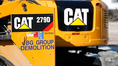 This May 8, 2019 photo shows a Caterpillar 279D Compact Track Loader, left, and 308E2 CR Mini Hydraulic Excavator, right, rear, at a demolition site in Fort Lauderdale, Fla.