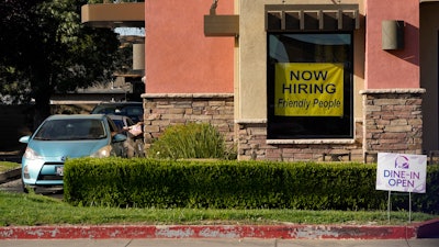 A hiring sign hangs in the window of a Taco Bell in Sacramento, Calif., Thursday, July 15, 2021.