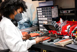 In this April 28 photo, an employee manually assembles a circuit-board element before a ribbon-cutting ceremony to mark the opening of a Nanotronics manufacturing center at the Brooklyn Navy Yard in the Brooklyn borough of New York.