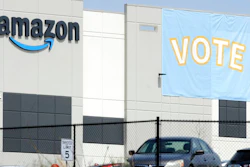 In this March 30, 2021 file photo, a banner encouraging workers to vote in labor balloting is shown at an Amazon warehouse in Bessemer, Ala. The union that tried, and failed, to organize Amazon warehouse workers in Bessemer, says it may get a do-over. The Retail, Wholesale and Department Store Union on Monday, Aug. 2 said that a hearing officer for the National Labor Relations Board has recommended that the vote by workers in April to overwhelmingly reject the union be set aside and that another vote be held in its place.