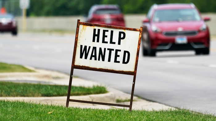 In this Tuesday, July 27, 2021, file photo, a help-wanted sign is displayed at a gas station in Mount Prospect, Ill. The gulf between record job openings and a lack of people taking those jobs is forcing Wall Street to reassess the pace of the economic recovery.