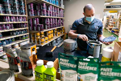 Billy Wommack, purchasing director at the W.S. Jenks & Sons hardware, opens a gallon of paint at the mixing station of the hardware store's paint department on Sept. 24 in northeast Washington.