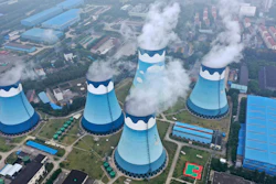 Steam billows out of the cooling towers at a coal-fired power station in Nanjing in east China's Jiangsu province on Monday, Sept. 27, 2021. Global shoppers face possible shortages of smartphones and other goods ahead of Christmas after power cuts to meet government energy use targets forced Chinese factories to shut down and left some households in the dark.