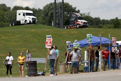 In this June 18, 2021 file photo, UAW Members strike outside the Volvo Trucks North America plant in Dublin, Va. With Help Wanted signs at factories and businesses spreading across the nation, in manufacturing and in service industries, union workers like those at the Volvo site are seizing the opportunity to try to recover some of the bargaining power — and financial security — they feel they lost in recent decades as unions shrank in size and influence.
