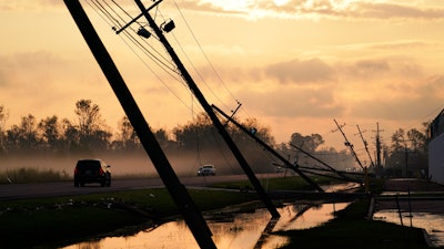 Downed power lines slump over a road in the aftermath of Hurricane Ida, Friday, Sept. 3, 2021, in Reserve, La.