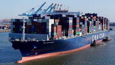 In this June 30, 2021 file photo a container ship leaves the Port of New York and New Jersey in Elizabeth, N.J. A major maritime industry association on Monday backed plans for a global surcharge on carbon emissions from shipping to help fund the sector's shift toward climate-friendly fuels.