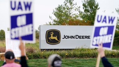 Members of the United Auto Workers strike outside of a John Deere plant, Wednesday, Oct. 20, 2021, in Ankeny, Iowa. The farm equipment manufacturer reached a tentative labor agreement Saturday, Oct. 30, with the United Auto Workers union.