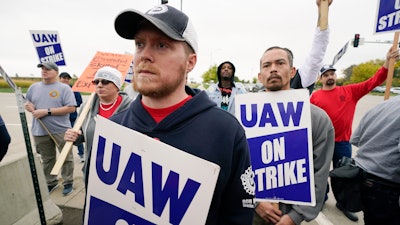 Members of the United Auto Workers listen to Agriculture Secretary Tom Vilsack speak outside of a John Deere plant, Wednesday, Oct. 20, 2021, in Ankeny, Iowa. About 10,000 UAW workers have gone on strike against John Deere since last Thursday at plants in Iowa, Illinois and Kansas.