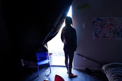 In this Feb. 23, 2021, file photo, Ricki Mills looks out from her home as she waits for a fire hydrant to be turned to get water, in Dallas on Feb. 23, 2021. Texas is again at high risk of power blackouts this winter because of extreme weather like the catastrophic February storm that buckled the state's electric grid and left millions of people without heat for days, regulators said Thursday, Nov. 18, 2021.