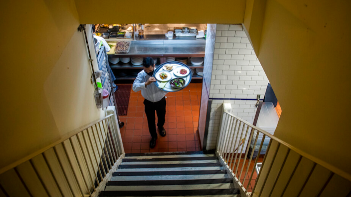 Muhammad Rahman delivers orders at Gotham restaurant on Dec. 14, 2021 in New York.
