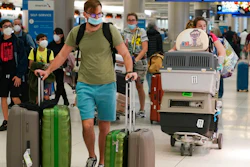 A family and their pets walk through Miami International Airport, on Dec. 20, 2021, in Miami.