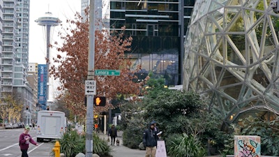 The Amazon Spheres on the company's corporate campus are shown near the Space Needle in downtown Seattle, Tuesday, Dec. 7, 2021. Amazon Web Services suffered a major outage Tuesday, the company said, disrupting access to many popular sites.