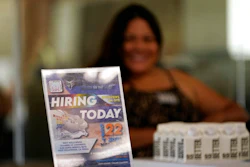 A hiring sign is placed at a booth for prospective employers during a job fair Wednesday, Sept. 22, 2021, in the West Hollywood section of Los Angeles. America’s employers slowed the pace of their hiring in November, adding a still-solid 210,000 jobs, the fewest in nearly a year. Friday, Dec. 3, report from the Labor Department also showed that the unemployment rate fell sharply to 4.2% from 4.6%.