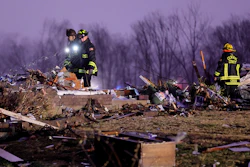Firefighters search a debris field that came from a house that was ripped off its foundation and trees were cut off after a tornado ripped along Highway F at the intersection of Stub Road in St. Charles County, Mo., on Friday, Dec. 10, 2021.