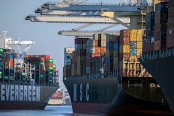 Container ship Ever Far, left, sails down river past the Port of Savannah, Ga., Sept. 29, 2021.