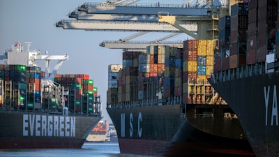 Container ship Ever Far, left, sails down river past the Port of Savannah, Ga., Sept. 29, 2021.