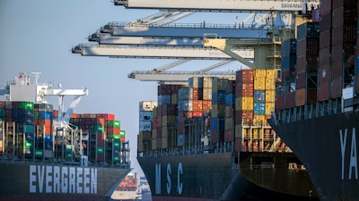 Container ship Ever Far, left, sails down river past the Georgia Ports Authority's Port of Savannah, Wednesday, Sept. 29, 2021, in Savannah, Ga. Inflation has spiked during the recovery from the pandemic recession as Americans have ramped up spending on such items as cars, furniture and appliances. Those increased purchases have clogged ports and warehouses and exacerbated supply shortages of semiconductors and other parts.