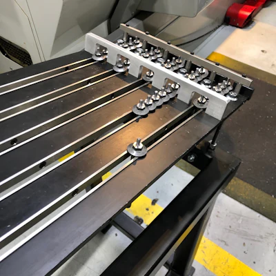 The feeding rack of the cold headed parts from which the robotic arm feeds the CNC machines.