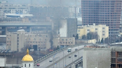 Smoke and flame rise near a military building after an apparent Russian strike in Kyiv, Ukraine, Feb. 24, 2022.