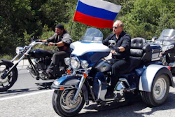 Russia's Prime Minister Vladimir Putin, foreground, rides a Harley-Davidson Lehman Trike as he arrives for the meeting with Russian and Ukrainian bikers at their camp near Sevastopol, in Ukraine's Crimea Peninsula, on July 24, 2010. Harley-Davidson halted motorcycle shipments to Russia and said its thoughts “continue for the safety of the people of Ukraine.”