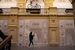 A visitor walks past a closed Dior boutique inside the GUM department store, Moscow, March 9, 2022.