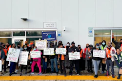 Amazon workers hold sigs after walking out of the Amazon DMD9 delivery station in Upper Marlboro, Md., on March 16, 2022.