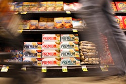 In this Feb. 9, 2011 photo, a shopper passes Nabisco products, a Mondelez International brand: Premium saltines, Triscuits, Ritz crackers and Wheat Thins, at a supermarket in Los Angeles. Ukrainian President Volodymyr Zelenskyy is stepping up the country's pleas to pressure companies to exit Russia.