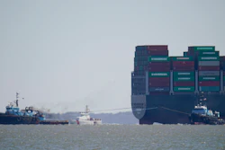 The tugboats Atlantic Enterprise, left, and Atlantic Salvor, bottom right, use lines to pull the container ship Ever Forward, top right, which ran aground in the Chesapeake Bay, Pasadena, Md., March 29, 2022.