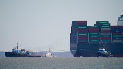 The tugboats Atlantic Enterprise, left, and Atlantic Salvor, bottom right, use lines to pull the container ship Ever Forward, top right, which ran aground in the Chesapeake Bay, Pasadena, Md., March 29, 2022.