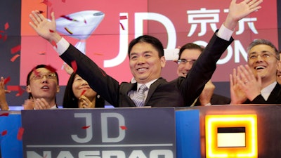 Liu Qiangdong, also known as Richard Liu, CEO of JD.com, raises his arms to celebrate the IPO for his company at the Nasdaq MarketSite, New York, May 22, 2014.
